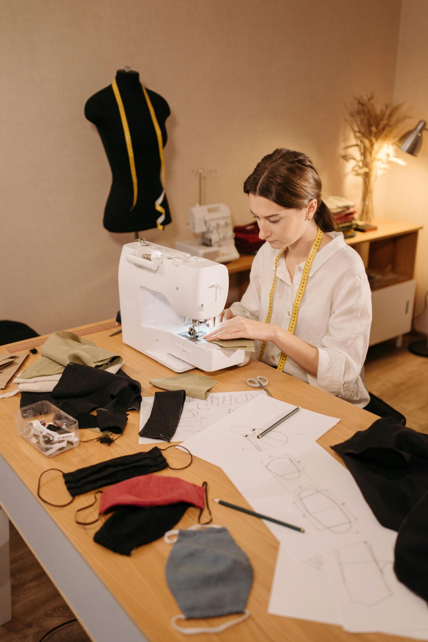 A dedicated seamstress sewing face masks in her home workshop space.